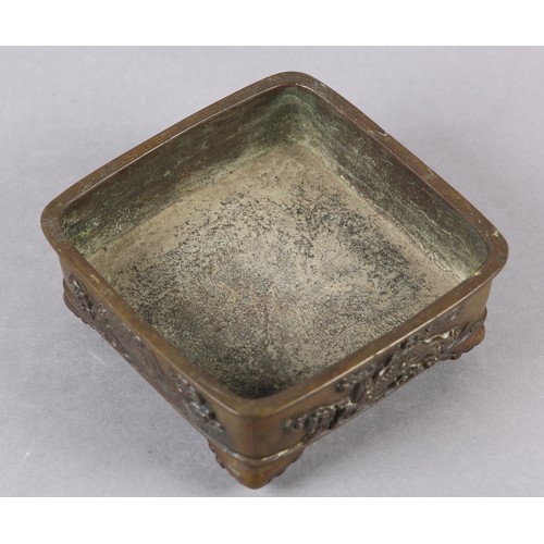 282 - A 19TH CENTURY CHINESE BRONZE CENSER, of square shallow form, the sides cast with alternating flying... 