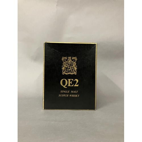 23 - TWO QE2 PRESENTATION BOXES.                                         1. BLACK POTTERY JUG            ... 