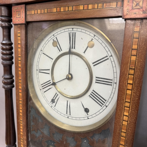 252 - A late 19th century German wall strike clock in an inlaid and veneered case, twin train spring movem... 