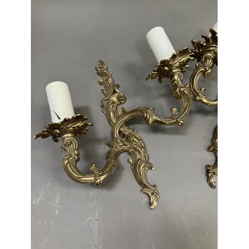 198 - A pair of gilt metal twin light wall moulded sconces, 32cm high