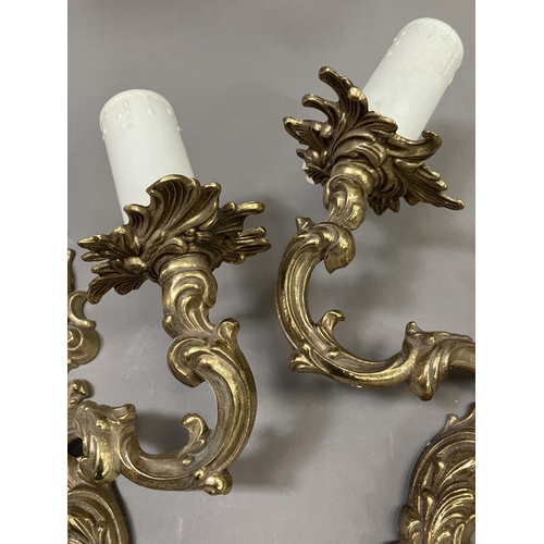 198 - A pair of gilt metal twin light wall moulded sconces, 32cm high