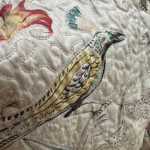 150 - A pair of 20th century quilted curtains, printed with decorative birds and flowers on a cream ground... 