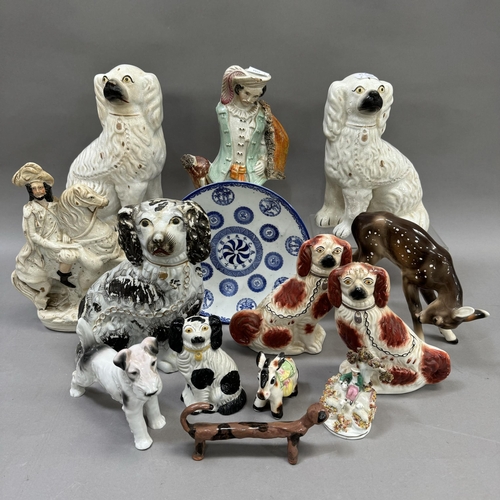 42 - A collection of 19th century and later Staffordshire spaniels including a black and white spotted ex... 