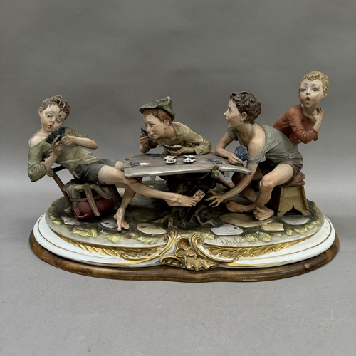 239 - A large Capodimonte  style figure group by Merli, The Card Cheats, signed to front, on wooden base, ... 