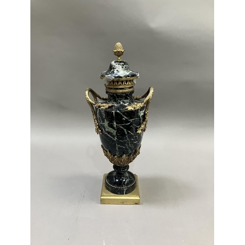 36 - A black and green marble cassolette, gilt metal mounted, the cove having acorn finial, with vine and... 