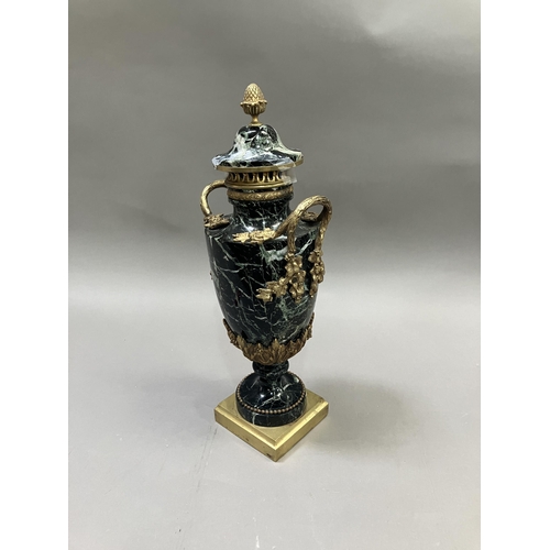 36 - A black and green marble cassolette, gilt metal mounted, the cove having acorn finial, with vine and... 