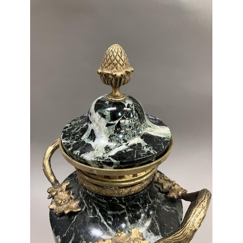 36 - A black and green marble cassolette, gilt metal mounted, the cove having acorn finial, with vine and... 