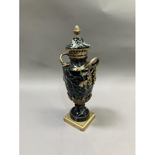 36 - A black and green marble cassolette, gilt metal mounted, the cove having acorn finial, with vine and... 