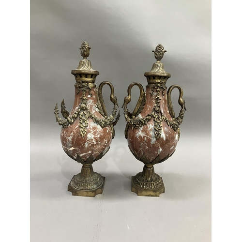 37 - A pair of red marble cassolettes, gilt metal mounted, the covers having fruiting finials, swan neck ... 