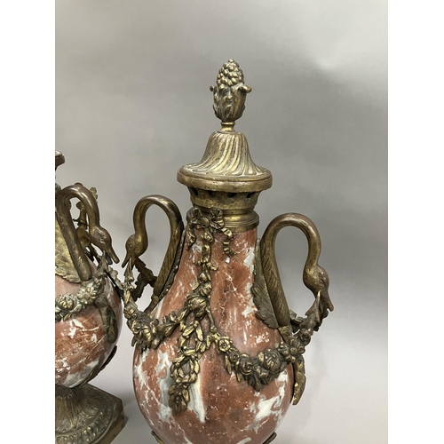 37 - A pair of red marble cassolettes, gilt metal mounted, the covers having fruiting finials, swan neck ... 