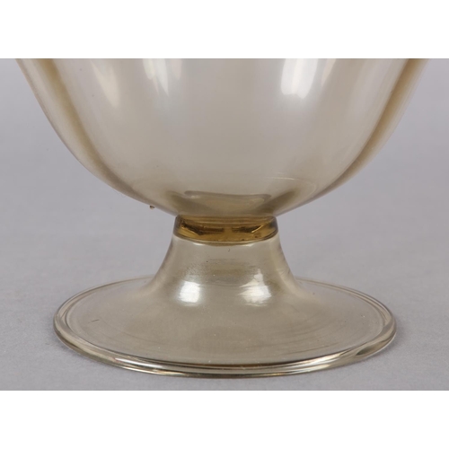 26 - A 19TH CENTURY MURANO PALE AMBER PEDESTAL BOWL, having a wavy everted rim of scalloped outline, on a... 