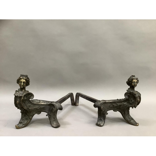 273 - A pair of French wrought iron fire dogs, each surmounted with the bust of a woman, 24cm high