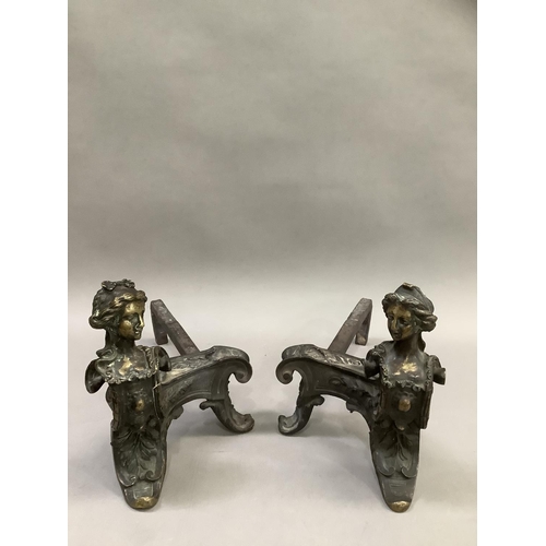 273 - A pair of French wrought iron fire dogs, each surmounted with the bust of a woman, 24cm high