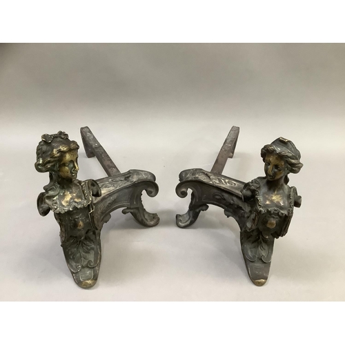 273 - A pair of French wrought iron fire dogs, each surmounted with the bust of a woman, 24cm high