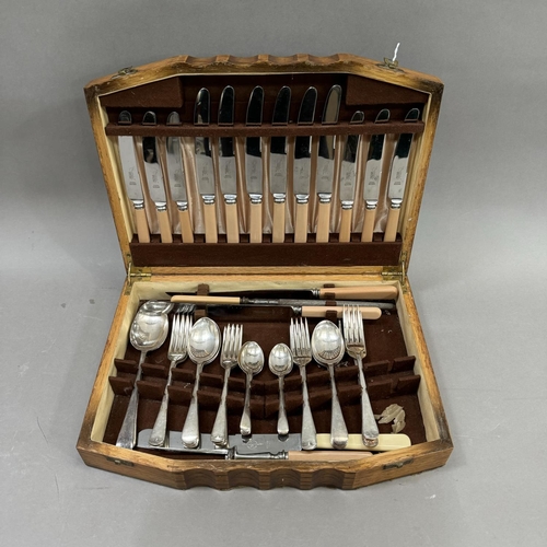 138 - An oak canteen of stainless steel cutlery with ivorine handles