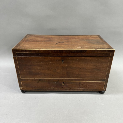 182 - A mahogany sewing workbox with satinwood inlay, on ball feet, having a fitted interior 45.5cm x 26cm