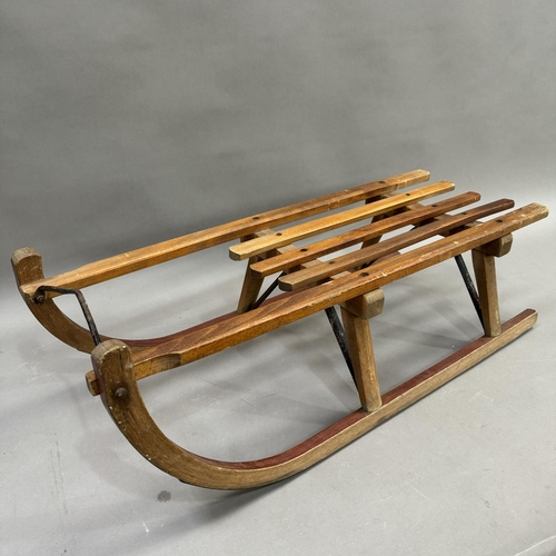 74 - A German wooden sledge stamped GDR to base, 82cm x 28cm