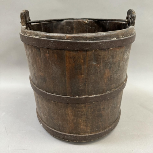 75 - A cast iron bound oak log bucket with swing handle 37.5cm high