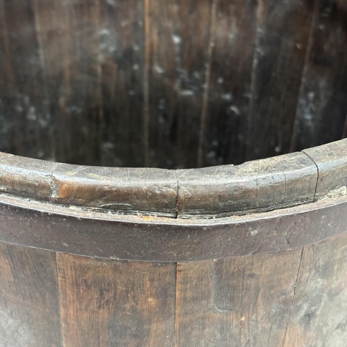 75 - A cast iron bound oak log bucket with swing handle 37.5cm high