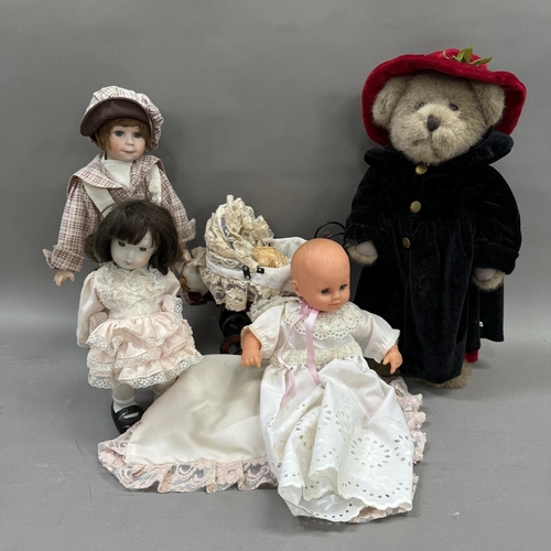 107 - A collection of dolls including a teddy bear