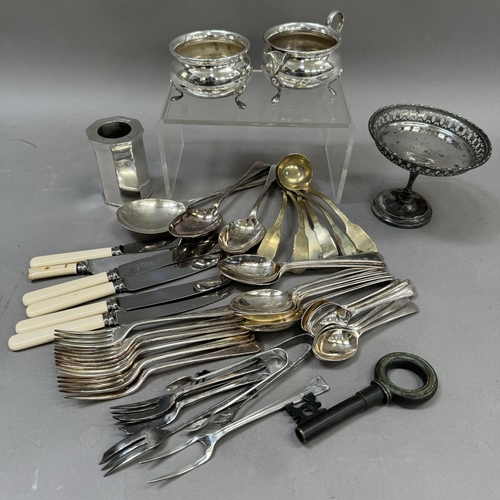 123 - A collection of EPNS including a circular picture frame, a tazza, flatware, a twin handled sugar bow... 