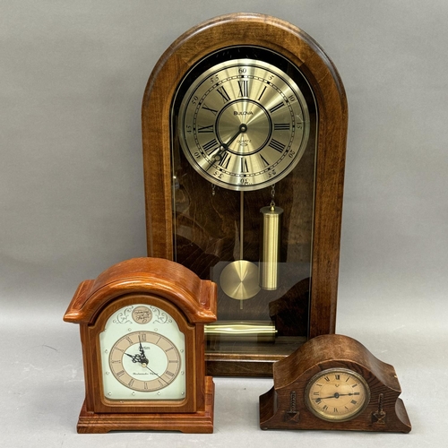 169 - An early 20th century oak mantle clock, a Tempus Fugit mantle clock and a Bulova wall clock