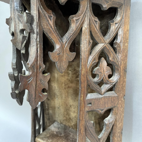 178 - An ecclesiastical oak niche the front carved with gothic tracery panels, backed in velvet 48.5cm hig... 