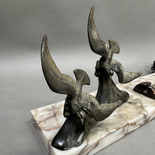 200 - An Art Deco style desk stand of marble having a model of two bronze birds to one edge and a globe li... 