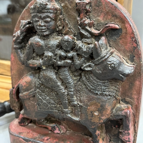 179 - A carved Indian wall plaque of a deity on a cow, three printing blocks with handles and a pine hangi... 