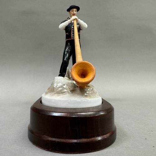 19 - Royal Worcester Alpine Cow Herder, Exclusively made for Switzerland Cheese, on a wooden plinth, 29cm... 