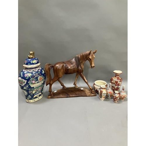 139 - A carved wooden horse on stand, 40cm high, a Chinese famille rose vase and cover with moulded finial... 