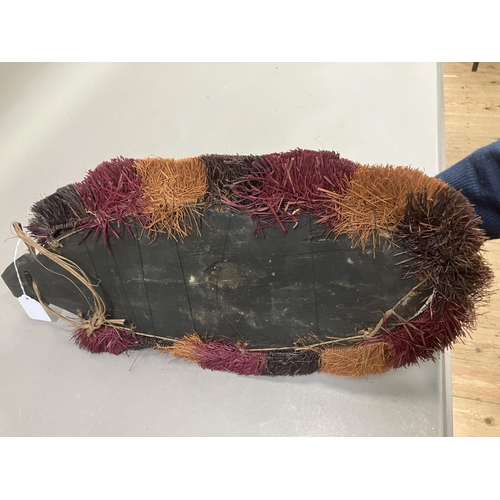 24 - A tribal mask from Papa New Guinea, the face painted and applied with cowrie shells, 51cm high