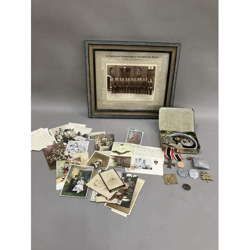 145 - A Nazi war merit cross, various other German medals, a framed photograph of Prussian soldiers, and m... 