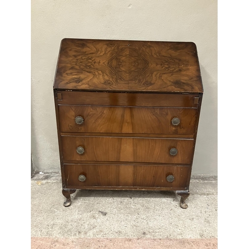 99 - A mahogany bureau having a fall front with fitted interior over three drawers on cabriole legs 73.5c... 