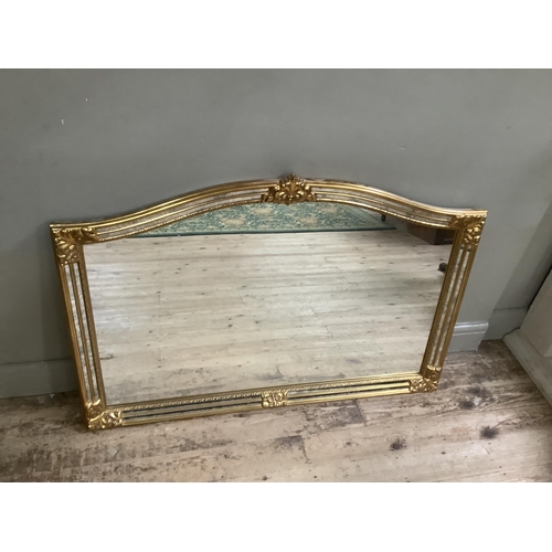 237 - A gilt overmantle mirror, having mirrored borders within moulded edges decorated with floral scrolls... 