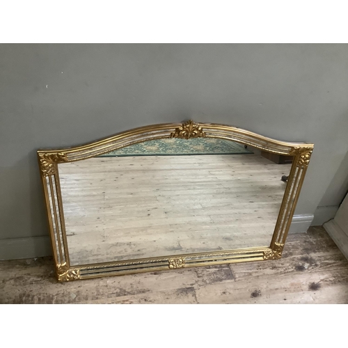 237 - A gilt overmantle mirror, having mirrored borders within moulded edges decorated with floral scrolls... 