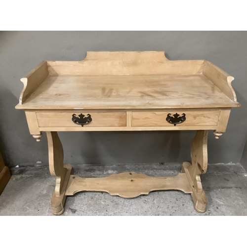 95 - A pine wash stand, having carved back panel, two drawers on single carved stretcher, 96.5cm wide