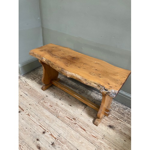 100 - A pine rough hewn bench with single stretcher, 102cm wide