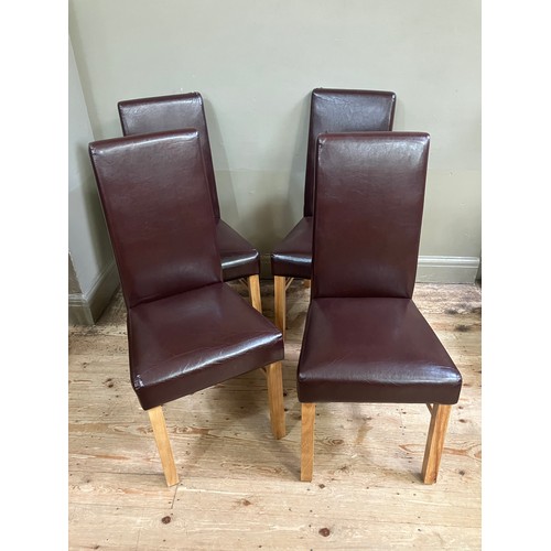 71 - Four faux leather dining chairs in burgundy