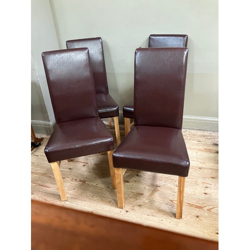 71 - Four faux leather dining chairs in burgundy