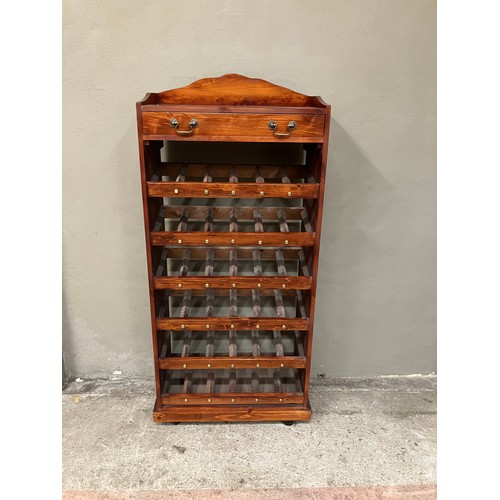 83 - A mahogany wine rack having six tiers with one long drawer