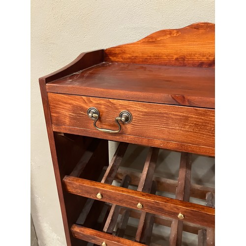 83 - A mahogany wine rack having six tiers with one long drawer