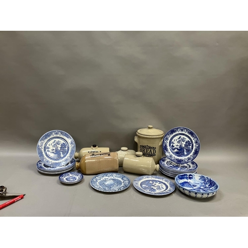 69 - A collection of stone glazed footwarmers, breadcrock etc together with blue and white Willow pattern... 