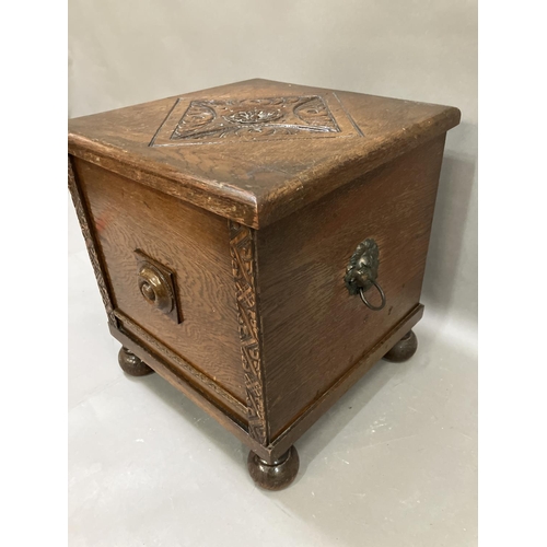 302 - An oak slipper box with twin lion mask handles on bun feet, 37cm x 35cm