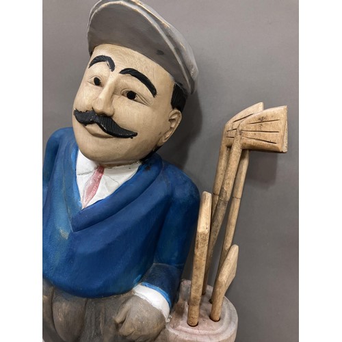 180 - A carved wooden painted figure of a golfer, 78cm high