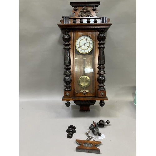 253 - A late 19th Century wall strike clock in a three light case with finials and pediment, the twin trai... 