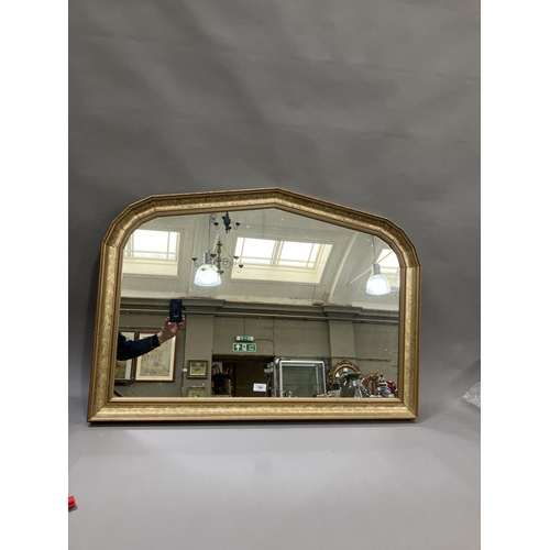 194 - A gilt overmantle arched decorative mirror 71cm x 101cm