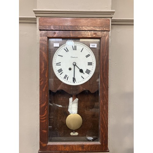 201 - An early to mid 20th century time clock by Simplex wall mounted in an oak case, single train fuseé m... 