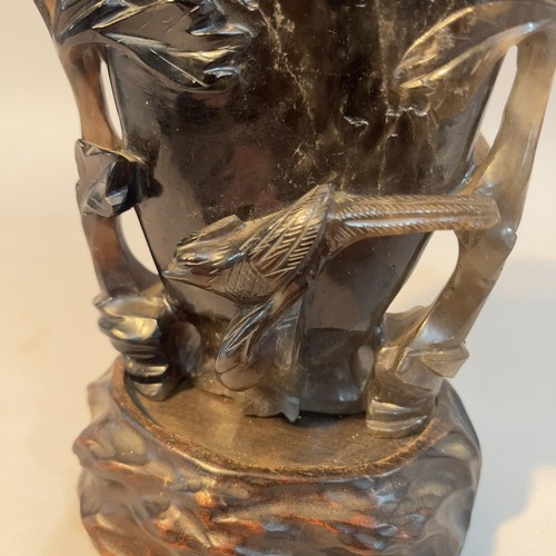 5 - A Chinese dark grey quartz vase carved in relief with flowering branches and bird, 13.5cm high with ... 