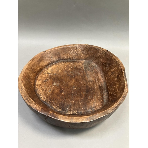 210 - A fruitwood treen bowl, rough hewn carved, 43cm wide